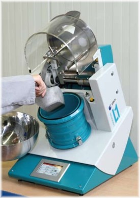 Operator filling powder into an Eirich mixer L1